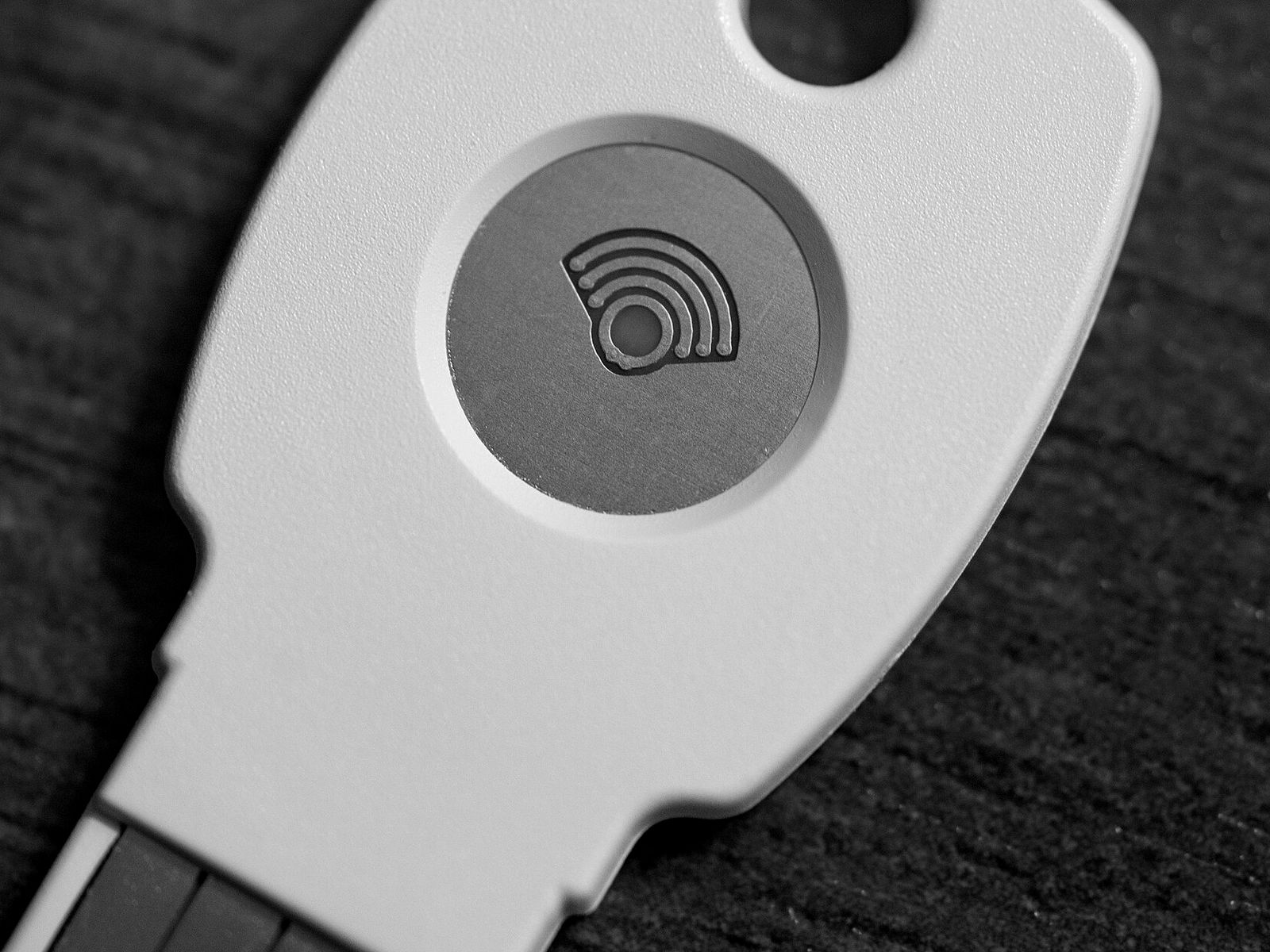 A security key for two-step sign-in, close up on a wooden table