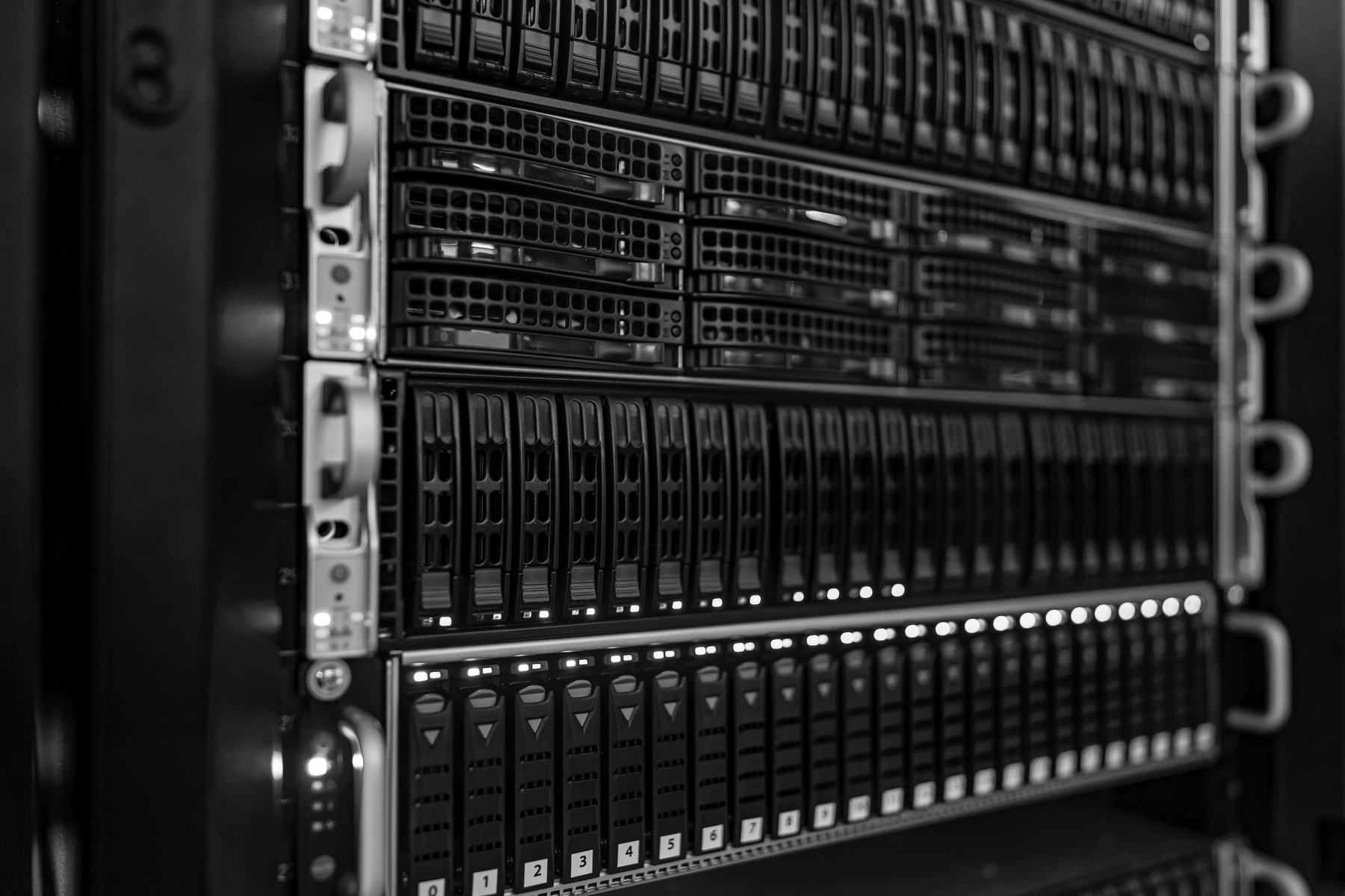 Servers stacked in a data centre rack, their drives in rows and their status lights on